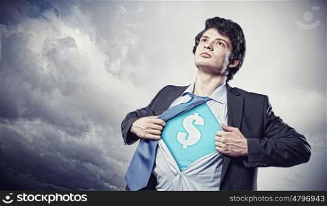 Businessman showing superman suit underneath shirt. Image of young businessman in superhero suit with dollar sign on chest