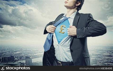 Businessman showing superman suit underneath shirt. Image of young businessman in superhero suit with pound sign on chest
