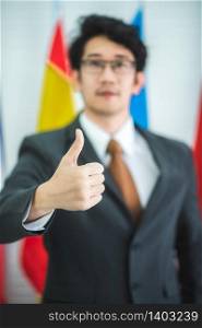 Businessman showing thumbs up, concept of successful business