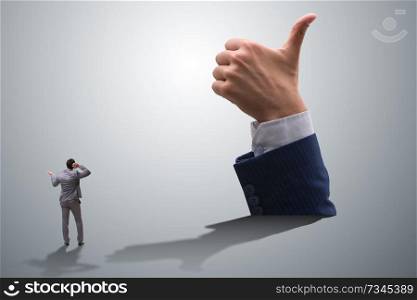 Businessman showing thumbs up gesture