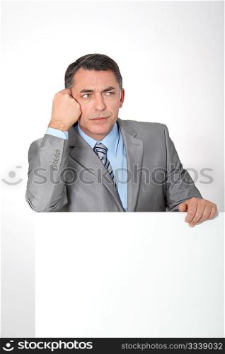 Businessman showing white message board