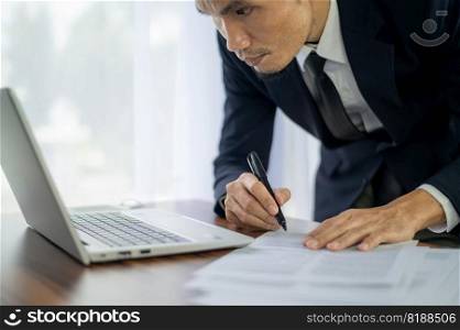 businessman signature document, Signing contract, business agreement, deal concept. Business man signing official contract, formal document with a pen and using laptop computer on table