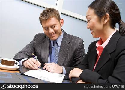 Businessman signing agreement on lunch