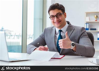 Businessman signing business documents in office