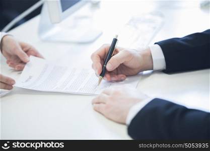 Businessman signing contract. Businessman hands with contract giving it to partner for signing