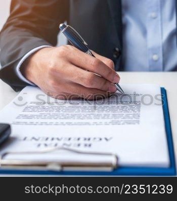 Businessman signing contract document. Rental contract, insurance, and contract agreement concepts