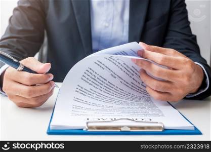 Businessman signing on contract documents after reading, man holding pen and approve on business report. Contract agreement, partnership and deal concepts