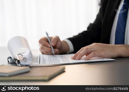 Businessman signs contract agreement paper or business legal form with trust and professionalism. Closeup of hand holding pen in corporate meeting for official business deal. Equilibrium. Closeup hand of businessman singing contract agreement paper. Equilibrium