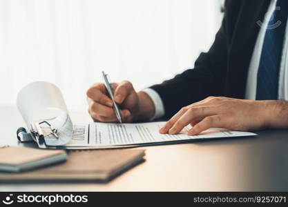 Businessman signs contract agreement paper or business legal form with trust and professionalism. Closeup of hand holding pen in corporate meeting for official business deal. Equilibrium. Closeup hand of businessman singing contract agreement paper. Equilibrium