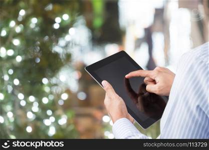 businessman sit and use tablet for work with bokeh background
