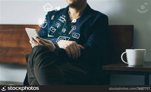 Businessman sit on wooden chair using smart phone with infographic effects of analyst marketing and finance of business growing.
