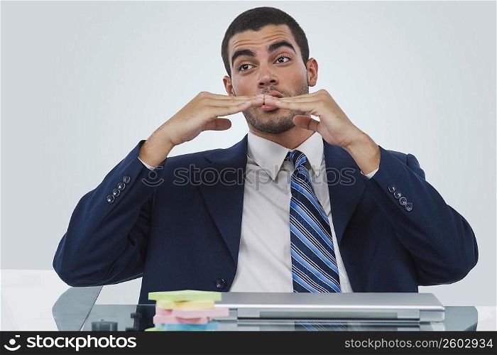 Businessman sitting at a desk and gesturing