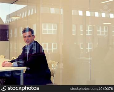 Businessman sitting at conference desk
