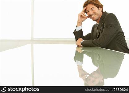 Businessman sitting at conference table portrait