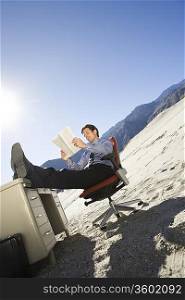 Businessman Sitting At Desk in the Desert