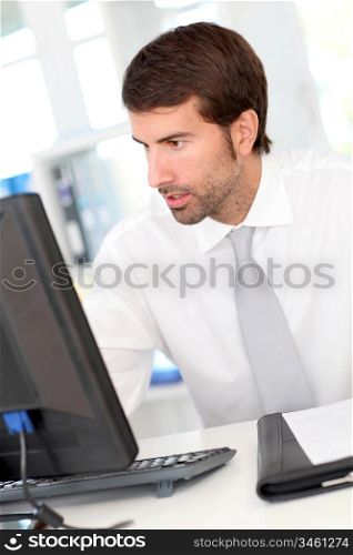 Businessman sitting at his desk in office