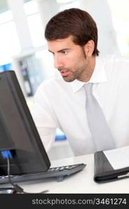 Businessman sitting at his desk in office