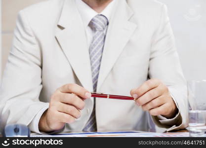 Businessman sitting at table and working in the office