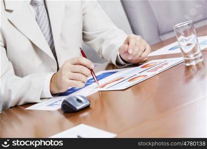 Businessman sitting at table and working in the office