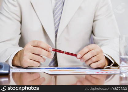 Businessman sitting at table and working in the office