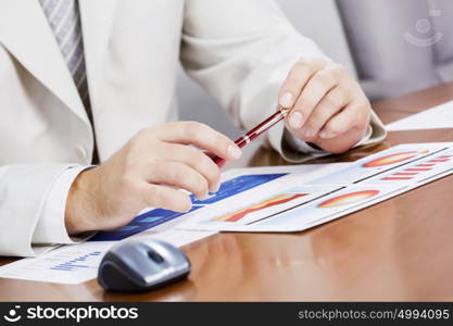 Businessman sitting at table and working in the office