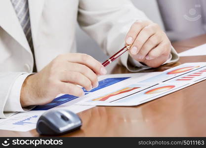 Businessman sitting at table and working in the office