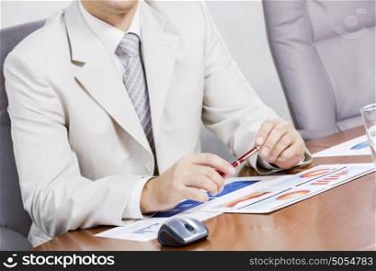 Businessman sitting at table and working in the office