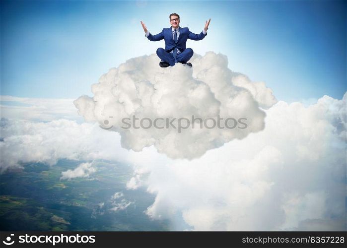 Businessman sitting at top cloud