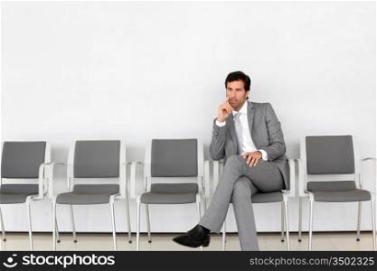 Businessman sitting in airport waiting room