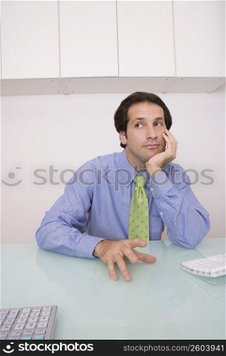 Businessman sitting in an office and thinking