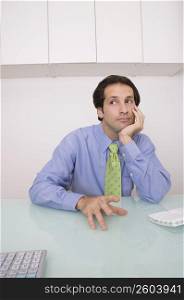 Businessman sitting in an office and thinking