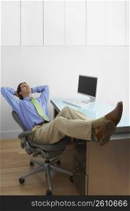 Businessman sitting in an office with his feet on the desk