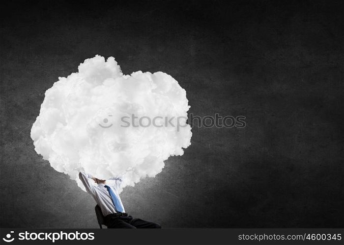 Businessman sitting in chair with cloud instead of head