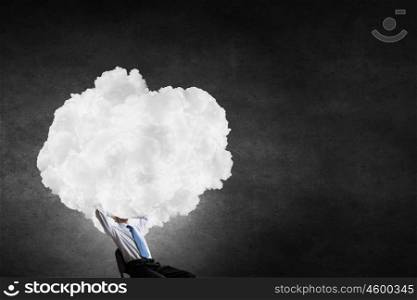 Businessman sitting in chair with cloud instead of head