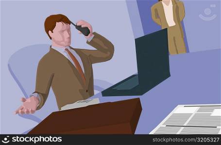 Businessman sitting in front of a laptop holding a cordless phone