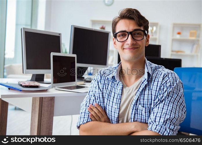 Businessman sitting in front of many screens