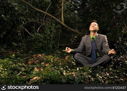 Businessman Sitting in Meditation Outside