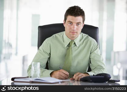 Businessman sitting in office with personal organizer