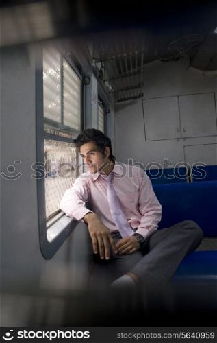 Businessman sitting inside a train