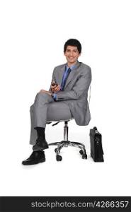 Businessman sitting on a chair and watching TV