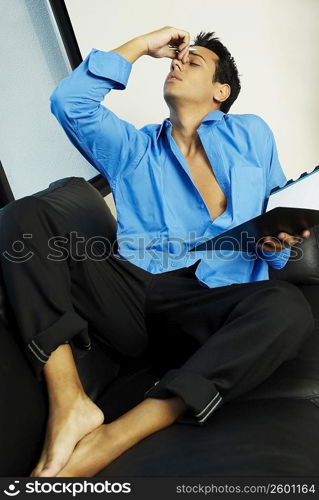 Businessman sitting on a couch and thinking