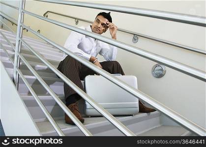 Businessman Sitting on a Stairway