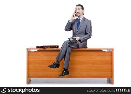 Businessman sitting on desk and speaking phone