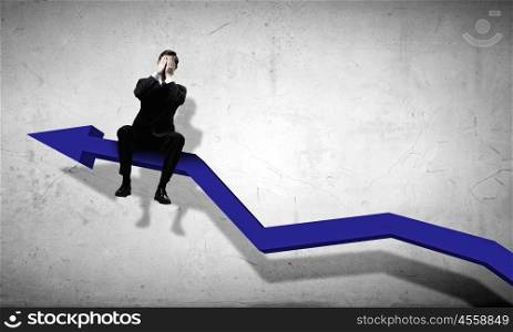 Businessman sitting on graph. Young businessman sitting on arrow with closed eyes