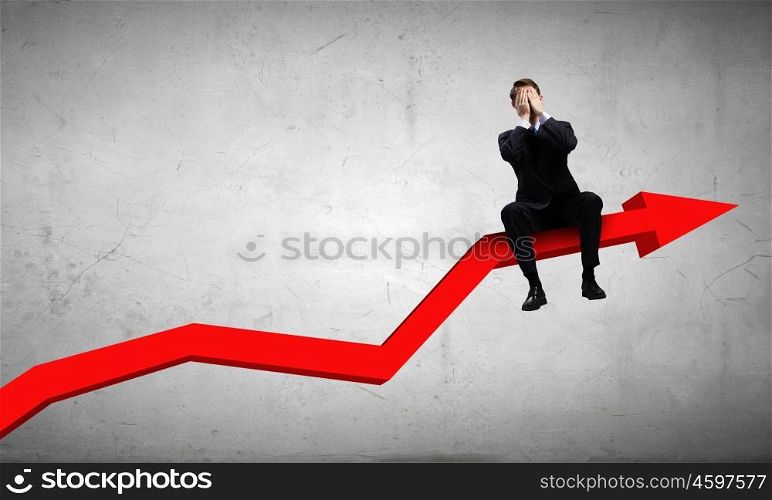 Businessman sitting on graph. Young businessman sitting on red arrow with closed eyes