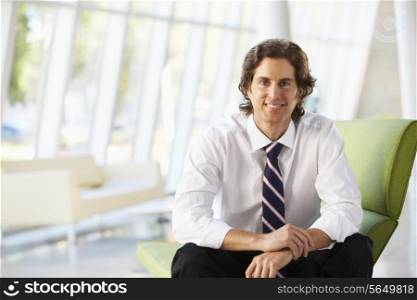 Businessman Sitting On Sofa In Modern Office