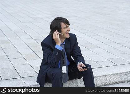 Businessman sitting on steps