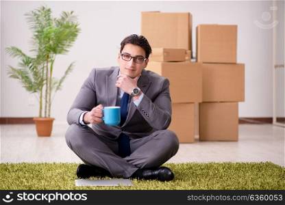 Businessman sitting on the carpet in office