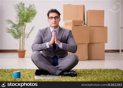 Businessman sitting on the carpet in office