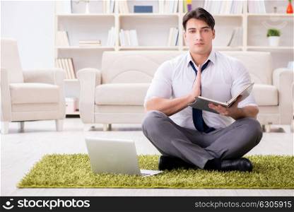 Businessman sitting on the floor in office
